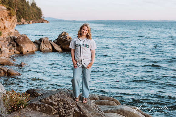 Young woman at the beach with baseball jersey